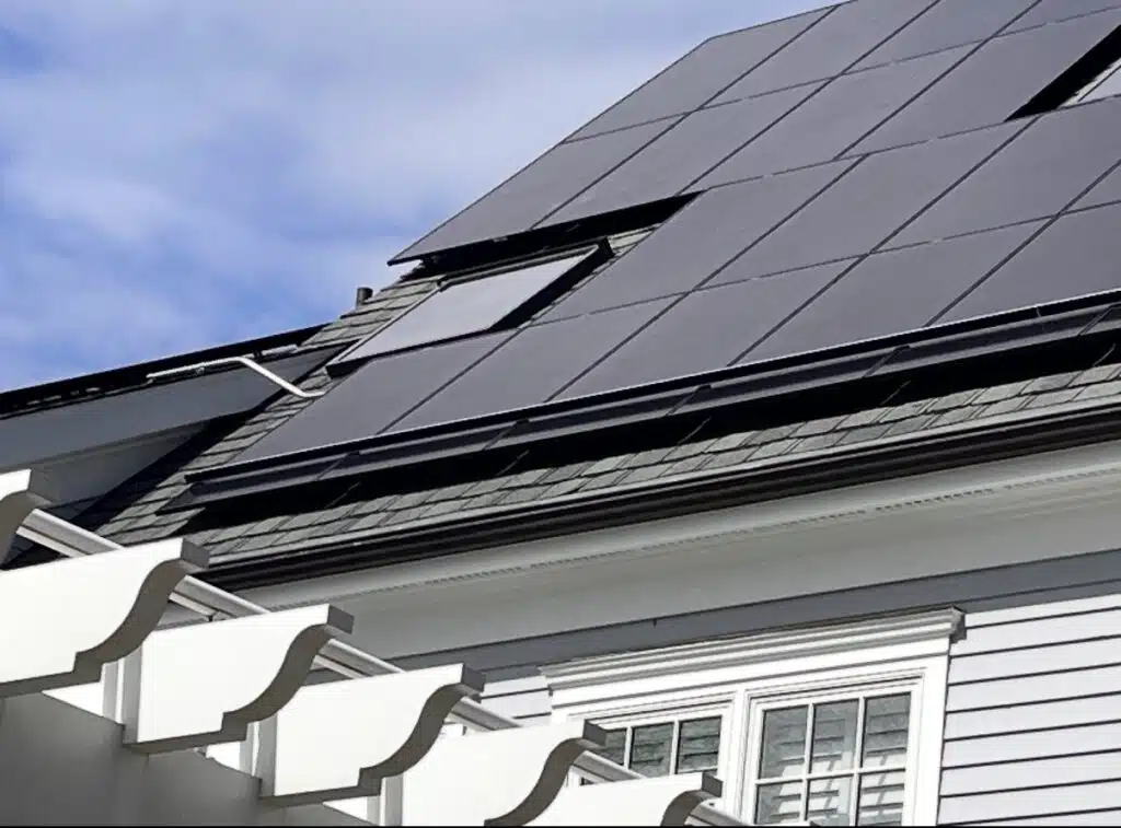 Solar panels installed on a residential roof with snow guard system visible along the lower edge